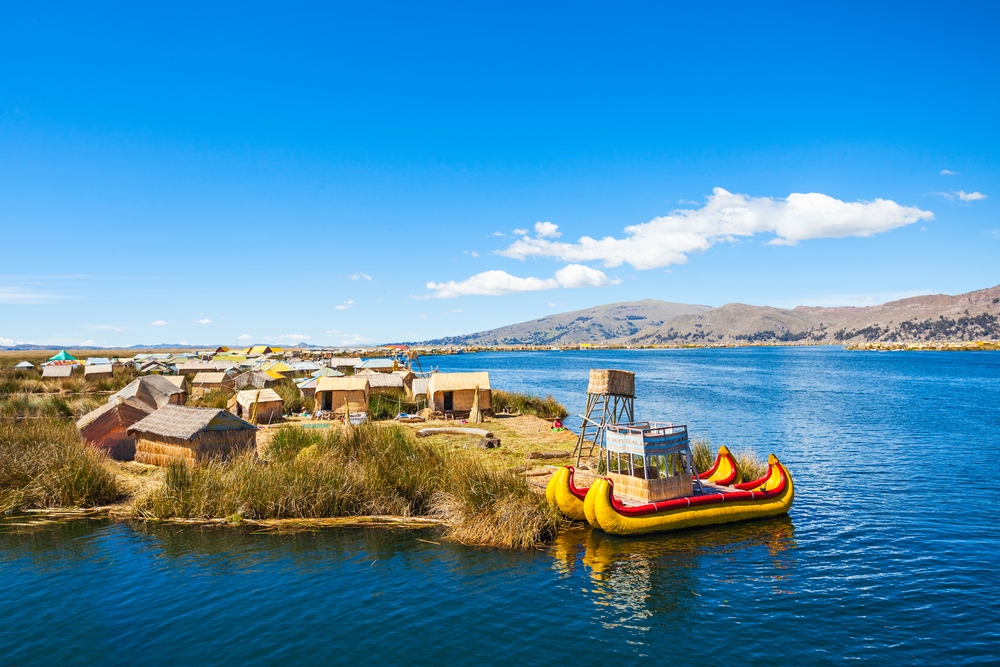 reed boats on lake titicaca with reed sheds in background reed boats on lake titicaca with reed sheds in background