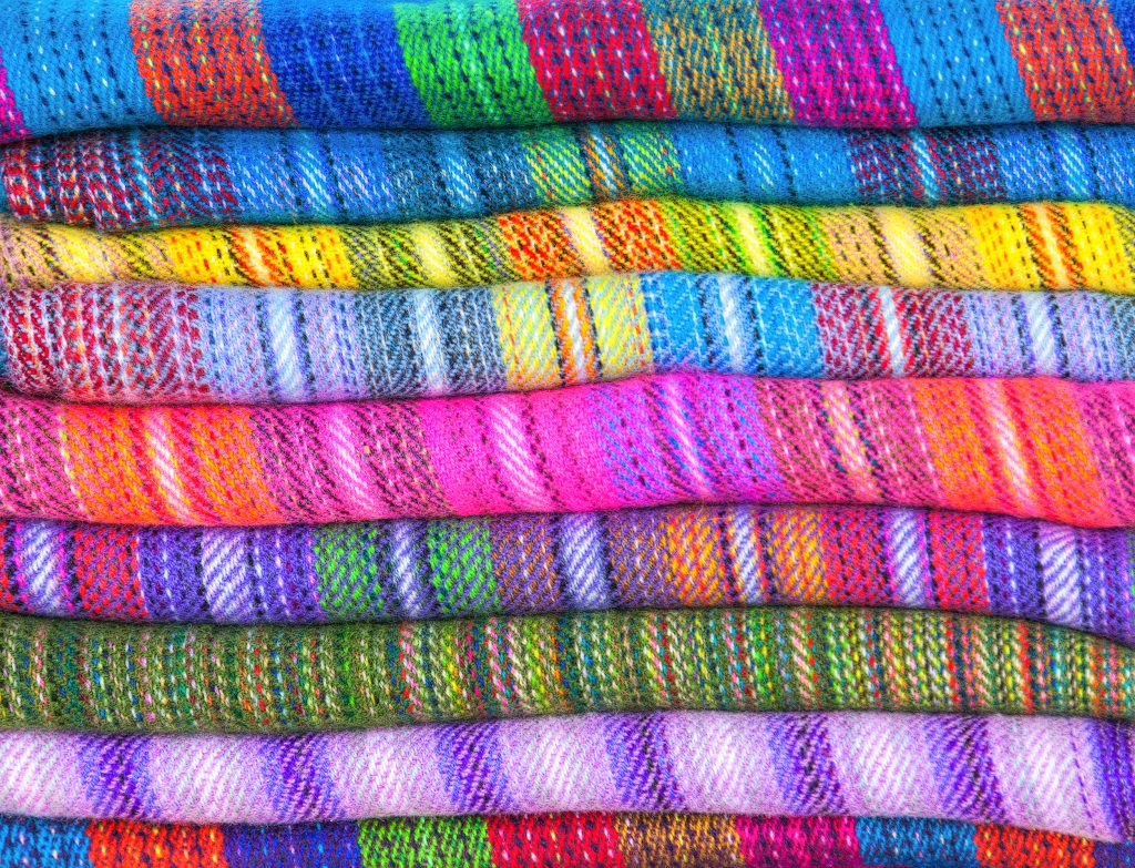 A pile of brightly coloured fabrics of wool lama and alpaca in market Uyuni, Peru, Latin America Credit: Shutter stock A pile of brightly coloured fabrics of wool lama and alpaca in market Uyuni, Peru, Latin America Credit: Shutter stock