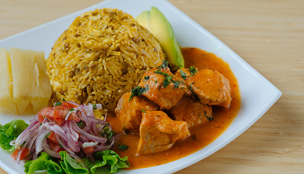 Stew of meat served with rice, lentils, salad and avocado Stew of meat served with rice, lentils, salad and avocado