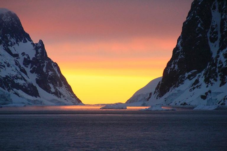 Weather in Antarctica: sunset between snowy mountains in antarctica Weather in Antarctica: sunset between snowy mountains in antarctica