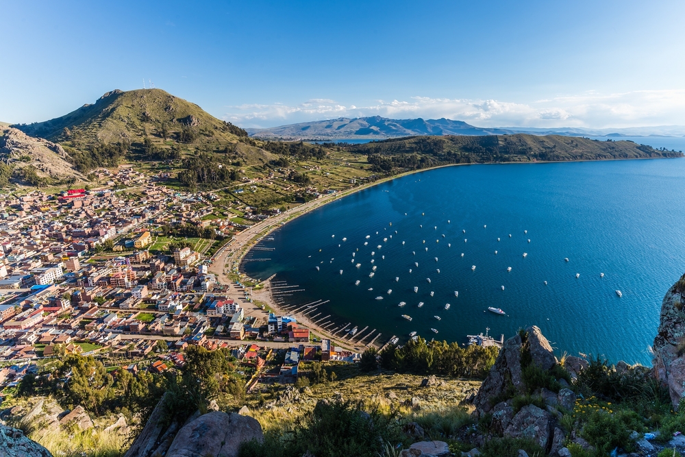 aerial view over the city copacobana and lake titicaca with mountains in the background aerial view over the city copacobana and lake titicaca with mountains in the background
