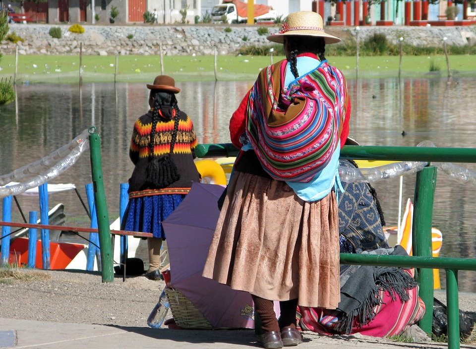 local peruvian woman waiting next to river local peruvian woman waiting next to river