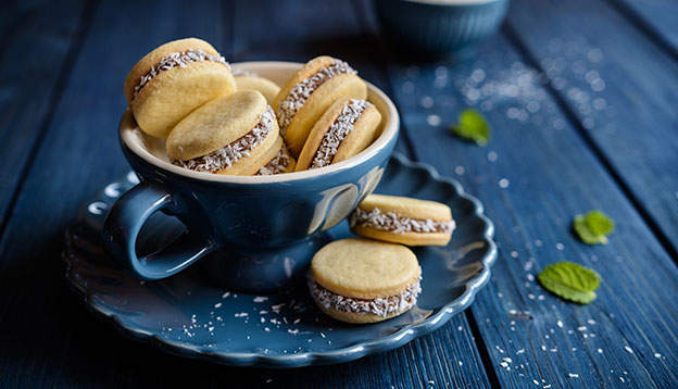 Alfajores - traditional sandwich cookies filled with caramelized milk and coconut Alfajores - traditional sandwich cookies filled with caramelized milk and coconut