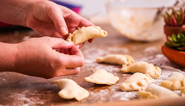 Close up of hands making homemade empanadas Close up of hands making homemade empanadas