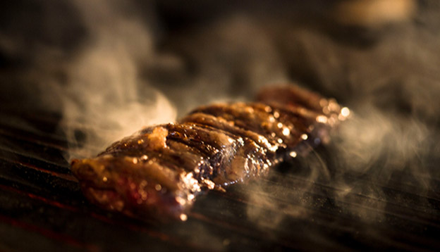 Close up of meat being cooked on a grill - Asado Close up of meat being cooked on a grill - Asado