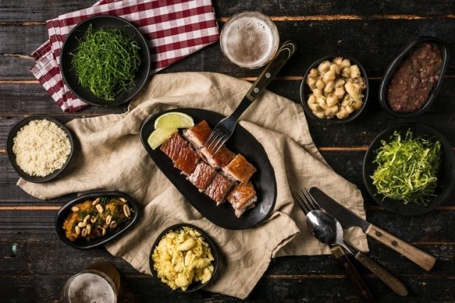 Close up of a table setting with pork and side dishes Close up of a table setting with pork and side dishes
