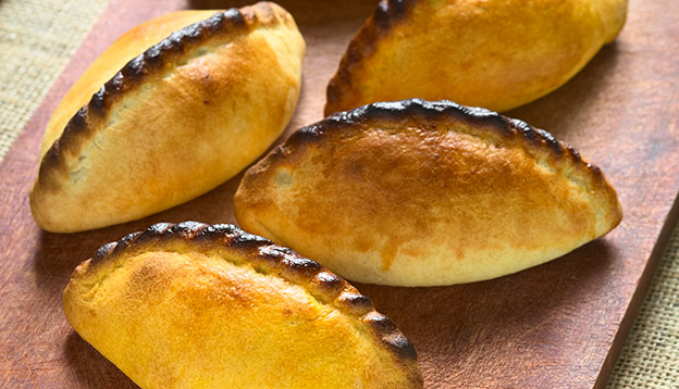 Traditional Bolivian savory pastry called Saltena filled with thick meat stew, which is a popular street snack in Bolivia. Traditional Bolivian savory pastry called Saltena filled with thick meat stew, which is a popular street snack in Bolivia.