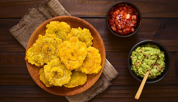Patacones - fried and flattened pieces of green plantain, traditional snack or accompaniment Patacones - fried and flattened pieces of green plantain, traditional snack or accompaniment