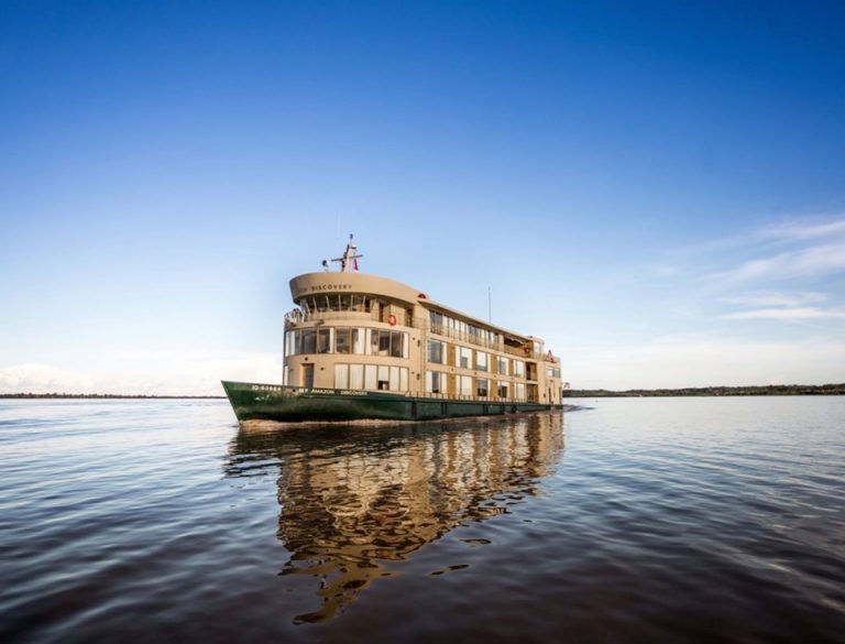 Explore the Amazon: photo of a small ship cruising the Amazon river Explore the Amazon: photo of a small ship cruising the Amazon river