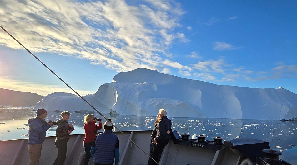 M/S Balto - guests on front deck of ship looking at Arctic ice 