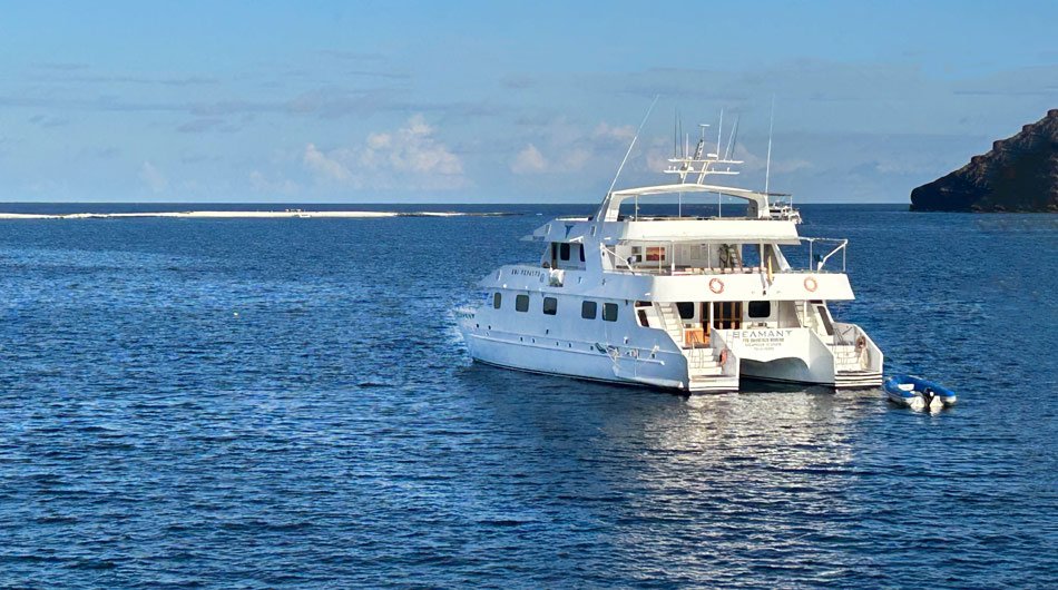 Seaman Journey ship cruising the Galapagos Islands with sand bar in the background