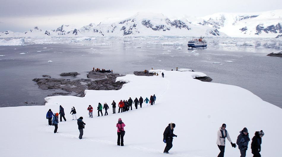 Ocean Nova in Antarctica with people at a landing