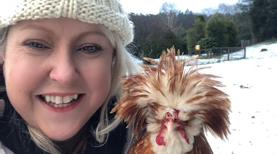 Chris Perry in the snow with a chicken 