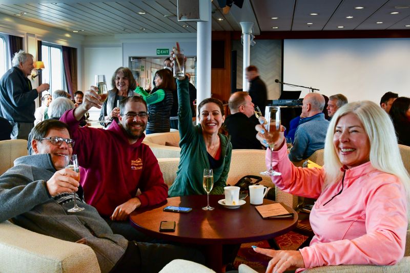 Travellers celebrating on an Antarctica expedition cruise. 
